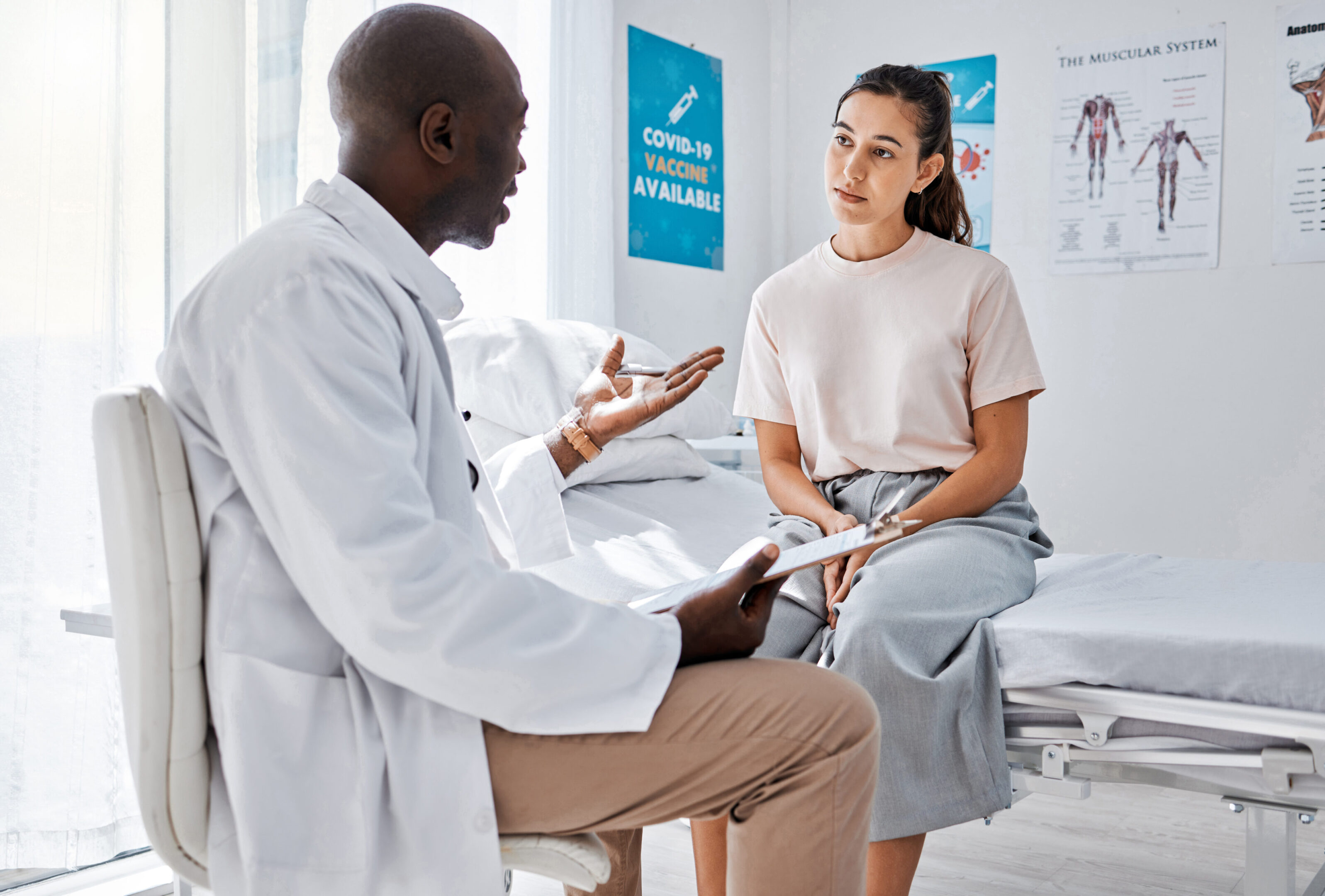Doctor consulting patient for covid vaccine, wellness check and medical test results in clinic surgery. Healthcare worker and hospital staff in discussion about medicine service and healthy feedback Restore Health Family PracticevRestore Health Family Practice